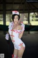 A woman dressed as a nurse posing for a picture.