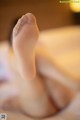 A close up of a person's feet on a bed.