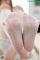 A close up of a woman's feet in sheer stockings.