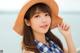 A young woman wearing a straw hat on the beach.