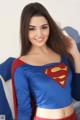 A woman in a superman costume posing for a picture.