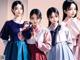 A group of young women in hanbok standing next to each other.