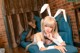 A woman in bunny ears laying on a blue chair.