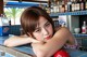 A woman leaning on a counter in a bar.