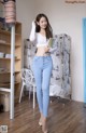 a woman standing in front of a closet holding a book